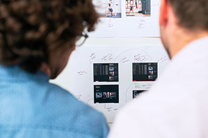 two people planing an app build looking at a project board